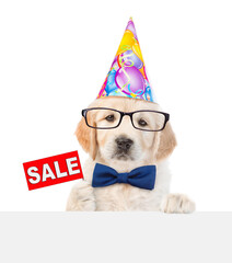 Poster - Funny Golden retriever puppy wearing tie bow, eyeglasses and party cap shows signboard with labeled 