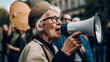 Pensioner caucasian woman hold megaphone and protesting in city. Concept against pension reform demonstration, elderly female activist protesting, strike with group banner