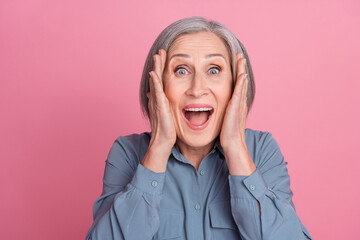 Sticker - Photo of astonished crazy woman with gray hairstyle dressed blue stylish shirt palms on face open mouth isolated on pink background