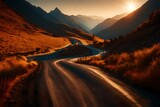 Fototapeta Niebo - Winding road in the mountains at sunset, stretching into the distance