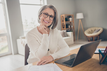 Wall Mural - Photo of dreamy good mood elderly lady specialist wear white cardigan communicating modern device indoors apartment room