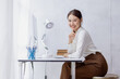 © David - Attractive smiling young asian business woman work in the office, Asian woman working on laptop computer holding tablet.