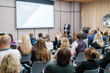 © Anton Gvozdikov - Back view of businesswoman attending presentation with diverse participants in conference hall