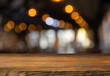 © kishivan - Empty wood table top and blur of cafe restaurant in dark night background. High quality photo