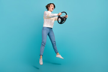 Poster - Full size body cadre of jump professional fast need for speed game simulator steering wheel girl driver isolated on blue color background