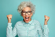 Elderly exultant overjoyed jubilant woman 50s years old wear light striped shirt look camera spread hands say wow isolated on plain pastel blue cyan color background studio portrait Lifestyle concept