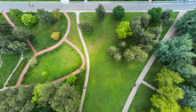 Urban Park With Meadow Trees And Paths Top View Aerial Photo From Flying Drone Of A City Park With Walking Path And Green Zone Trees In Evening Time