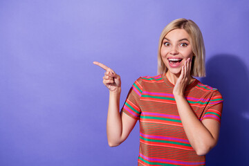 Wall Mural - Photo of excited overjoyed girl blonde bob hair promoter point finger empty space new role in company isolated on purple color background