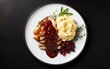 © AZ Studio - A Thanksgiving dinner plate, featuring all the traditional favorites - turkey, stuffing, mashed potatoes, and cranberry sauce on a black background, in a flat lay, overhead shot with copy space