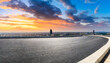 round asphalt road and city skyline with colorful sky clouds at sunset