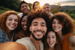 © Dennis - Diverse group of young adult friends taking a group selfie together, smiling in the camera