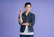 © STOCK88PHOTOGRAPHER - Image of Asian man posing on purple background