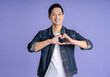 © STOCK88PHOTOGRAPHER - Image of Asian man posing on purple background