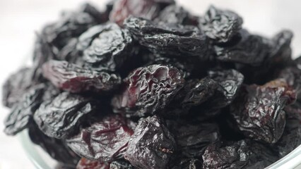 Wall Mural - black raisin on white background, close up,