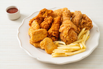 Sticker - fried chicken with french fries and nuggets on plate