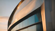 © xKas - Close-up of a modern building's textured exterior, highlighting the interplay of light and shadow against a sunset sky.