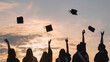 © Довидович Михаил - Student graduates toss their caps at sunset.