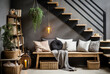 Wooden bench and book shelf against grey wall and staircase with black railings. Industrial interior design of modern entryway.