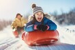 a Happy child rides a Tubing slide, Winter fun, Hobby recreation.