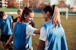 © Davor - Female football players stretching balancing on each other during practice