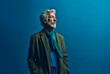 © artefacti - Older, Elegant Man in a Business Suit Poses Gracefully Against a Serene Blue Background, Symbolizing Timeless Sophistication and Authority, AI generated