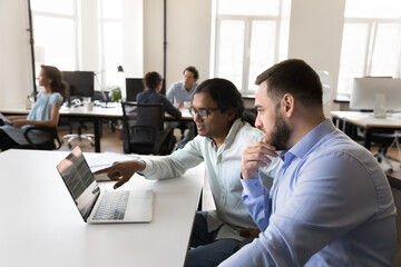 Sticker - Two multiethnic employees watching project presentation on laptop. Mentor showing job software to intern. Developer explaining online app work on computer to employee, executive