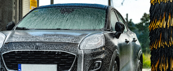 Wall Mural - A vehicle in an automatic car wash