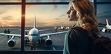 A girl at the airport window in the sunset looks at boarding for other flights. Generated by AI.