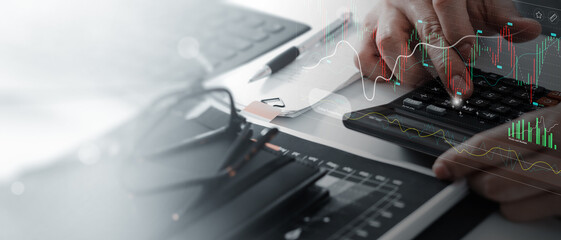 Wall Mural - businessman using calculator with marketing data growth graph and progress of business and analyzing