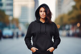 Fototapeta  - Woman wearing plain black hoodie for mockup. Fashion model female with black hoodie and neutral background. Black hoodie mockup.