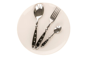 Wall Mural - Two metal spoons and fork with white ceramic plate on white background, macro, top view.