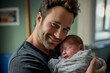 © Наталья Лазарева - a young father holds a newborn baby in his arms and gently looks at him and smiles