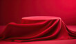 Cylinder podium covered with cloth on a red background.