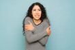 Hispanic woman feeling very cold with shivers during cold weather