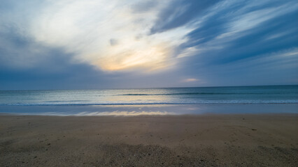 Calm beach shore under a bright blue sky in Tangier, Morocco