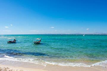 Hammamet Tunisia, Beach and  boats on shallow water, view on Mediterranean sea 