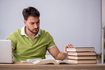 Wall Mural - Young male student sitting in front of whiteboard