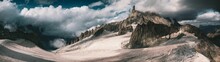 Panoramic Shot Of The Dry Rocky Mountains Reaching To The Clouds, Aosta Valley, Italy