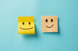 Positive attitude concept, one yellow and wheat color smiling sticky note emojis, happy face.