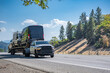 © vit - Powerful middle pick up truck transporting mini vans on semi trailer driving on the one way highway road intersection
