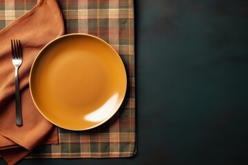 Wall Mural - Top down view of a table setting featuring a vacant plate knife fork and napkin allowing for creative use of empty space