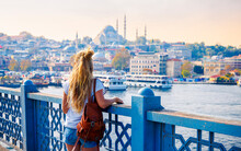 Traveler Woman Looking At Panoramic View Of Istanbul City, Eastern Tourist City- Travel, Vacation Or Tour Tourism In Turkey