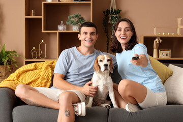 Poster - Young couple with cute Beagle dog at home