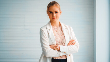 Attractive young woman profile portrait in office . Confident business person wearing formal suit working in corporate business. Jivy