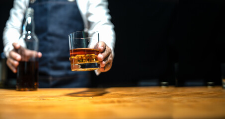 Wall Mural - Barman pouring whiskey whiskey glass..