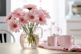Fototapeta Tulipany - Spring flowers in glass vase on wooden table. Blurred kitchen background with old chair. Bouquet of pink gerberas. Contemporary elegant scandi interior