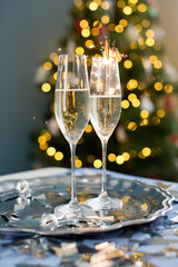 Wall Mural - Glasses with champagne near Christmas tree