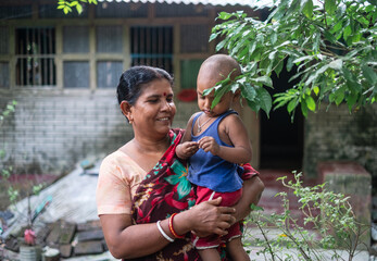 Wall Mural - South asian rural mother and son in traditional costumes 