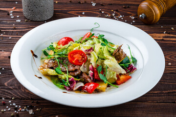 Wall Mural - Meat salad with cherry tomatoes, pork, lettuce and green peas.