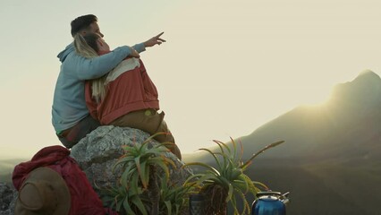 Canvas Print - Hiking, mountain and sunset, happy couple hugging and relax on outdoor adventure, peace in nature from back. Trekking, rock climbing and love, man and woman with view of sky sitting on cliff together